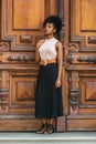 Young African American Woman Casual Fashion in New York, with afro hairstyle, wearing sleeveless light color top, black skirt, Royalty Free Stock Photo