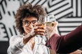 young african american woman clinking glasses of wine with boyfriend