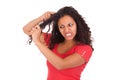 Young african american woman combing hair