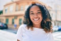 Young african american woman with curly hair smiling happy outdoors Royalty Free Stock Photo
