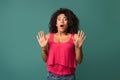 Young african-american woman disgusted over blue background