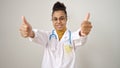 Young african american woman doctor doing thumbs up over isolated white background Royalty Free Stock Photo