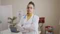 Young african american woman doctor standing with serious expression and crossed arms at clinic Royalty Free Stock Photo