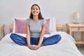Young african american woman doing yoga exercise sitting on bed at bedroom Royalty Free Stock Photo