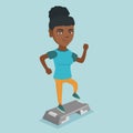 Young african-american woman exercising on steeper