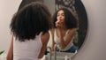 Young African American woman girl preparing morning beauty routine make-up cosmetic looking in mirror reflection Royalty Free Stock Photo