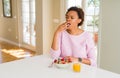 Young african american woman having healthy breakfast in the morning at home bored yawning tired covering mouth with hand Royalty Free Stock Photo