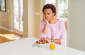 Young african american woman having healthy breakfast in the morning at home thinking looking tired and bored with depression Royalty Free Stock Photo