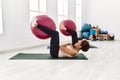 Young african american woman and hispanic man exercising at pilates room, stretching body and doing yoga pose, training strength Royalty Free Stock Photo