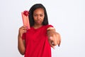 Young african american woman holding birthday present over isolated background pointing with finger to the camera and to you, hand Royalty Free Stock Photo