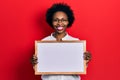 Young african american woman holding empty white chalkboard smiling with a happy and cool smile on face Royalty Free Stock Photo