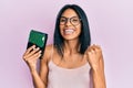 Young african american woman holding hard disk screaming proud, celebrating victory and success very excited with raised arms Royalty Free Stock Photo