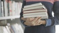 Young African American woman holding many books in hands Royalty Free Stock Photo