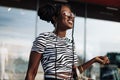 Young African American woman holding shopping bags while standing near shopping mall, Black Friday Royalty Free Stock Photo