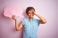 Young african american woman holding speech bubble over pink isolated background with happy face smiling doing ok sign with hand Royalty Free Stock Photo