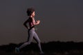 Young African american woman jogging in nature