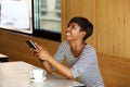 Young african american woman laughing with mobile phone Royalty Free Stock Photo