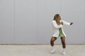 Young african american woman with long blond braids dancing in the street. Copy space Royalty Free Stock Photo