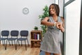 Young african american woman looking watch standing at waiting room Royalty Free Stock Photo