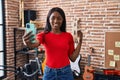 Young african american woman musician making selfie by the smartphone playing tambourine at music studio