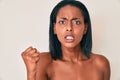 Young african american woman naked over background annoyed and frustrated shouting with anger, yelling crazy with anger and hand