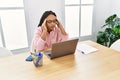 Young african american woman overworked working at office