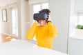 Young african american woman playing virtual reality game using simulation glasses headset, funny and amazed entertainment Royalty Free Stock Photo