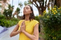 Young african american woman praying with closed eyes at park Royalty Free Stock Photo