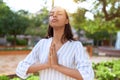 Young african american woman praying with closed eyes at park Royalty Free Stock Photo