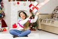 Young african american woman receive a Christmas gift. Happy excited dreaming girl about New Year presents. Christmas Eve, winter