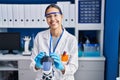 Young african american woman scientist using microscope at laboratory Royalty Free Stock Photo