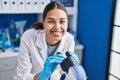 Young african american woman scientist using microscope at laboratory Royalty Free Stock Photo