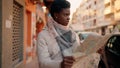 Young african american woman with serious expression holding city map at street Royalty Free Stock Photo