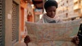 Young african american woman with serious expression holding city map at street Royalty Free Stock Photo