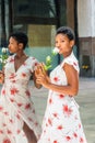 Young African American Woman holding a white rose, standing by mirror Royalty Free Stock Photo