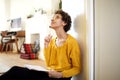 Young african american woman sitting on floor with pen and book thinking Royalty Free Stock Photo