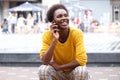 Young african american woman sitting outside talking on cellphone Royalty Free Stock Photo