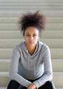 Young african american woman sitting on steps with headphones Royalty Free Stock Photo