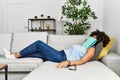 Young african american woman sleeping with book on face at home Royalty Free Stock Photo