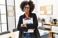 Young african american woman smiling confident holding clipboard at office Royalty Free Stock Photo