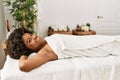 Young african american woman smiling confident lying on massage table at beauty center Royalty Free Stock Photo