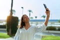 Young african american woman smiling confident making selfie by the smartphone at coffee shop terrace Royalty Free Stock Photo