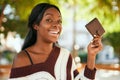 Young african american woman smiling happy holding leather wallet at the park Royalty Free Stock Photo