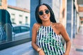 Young african american woman smiling happy leaning on the wall at the city Royalty Free Stock Photo