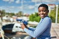 Young african american woman smiling happy using smartphone at the port Royalty Free Stock Photo