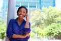 Young african american woman smiling with mobile phone Royalty Free Stock Photo