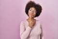 Young african american woman standing over pink background thinking concentrated about doubt with finger on chin and looking up Royalty Free Stock Photo