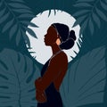 Young African American woman stands against the backdrop of the moon. Night in the jungle. Large tropical leaves Royalty Free Stock Photo