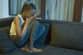 Young African American woman suffering depression - sad and depressed black teenager girl in pain at home sofa couch feeling Royalty Free Stock Photo