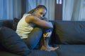 Young African American woman suffering depression - sad and depressed black teenager girl in pain at home sofa couch feeling Royalty Free Stock Photo